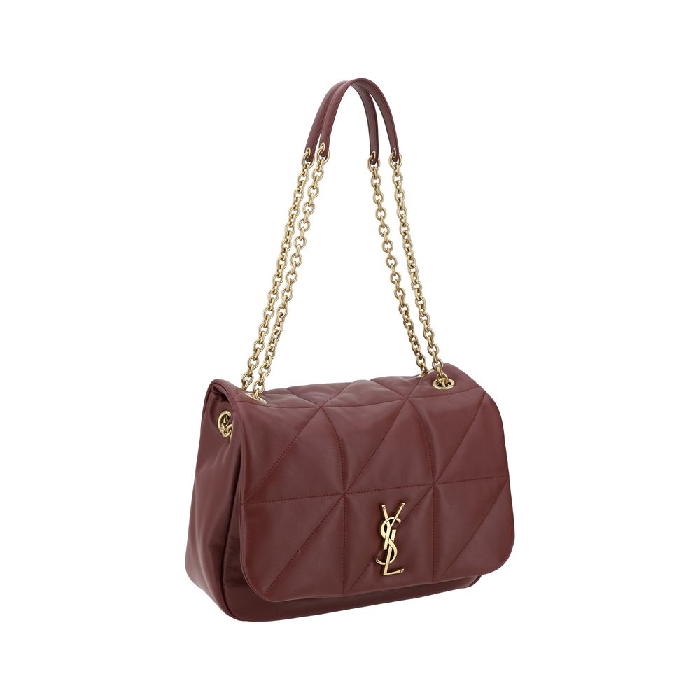 Close up of the front flap with snap-button closure and sliding chain shoulder strap with tassel detail