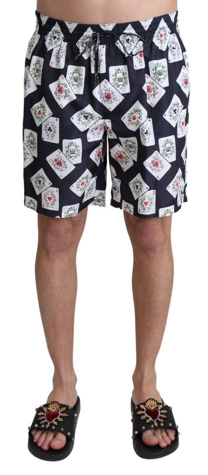 Vibrant multicolor card deck print swim trunks on sleek black backdrop