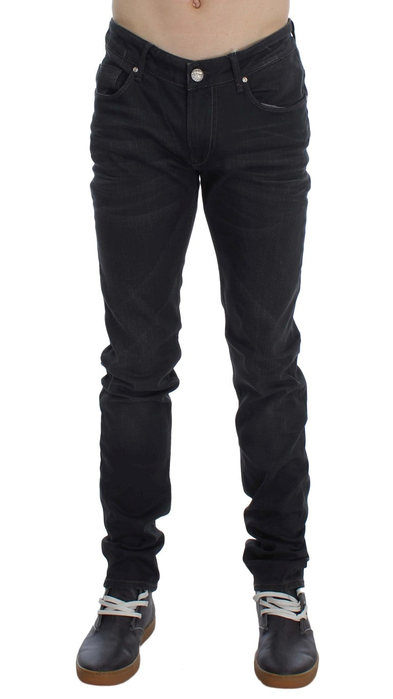 Close-up of Acht logo accents on men's slim-fit jeans