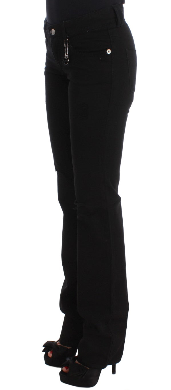 Close-up of the sleek black cotton fabric of Costume National Chic Black Slim Fit Zippered Cotton Jeans