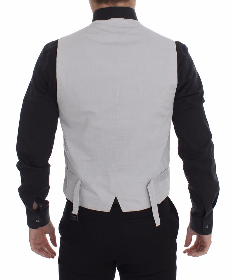 Sophisticated single-breasted design with a full front button closure and an adjustable back waist strap for a tailored fit