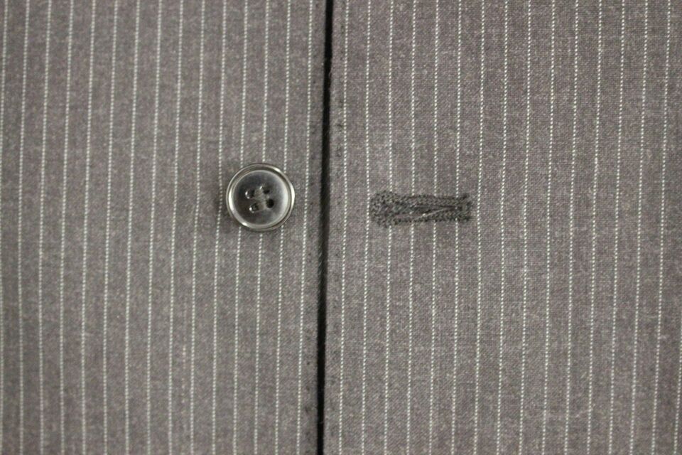 100% Authentic, brand new with tags, dress vest by Dolce & Gabbana in a classic gray stripe pattern exuding timeless sophistication, perfect for layering over professional or formal attire
