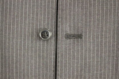 100% Authentic, brand new with tags, dress vest by Dolce & Gabbana in a classic gray stripe pattern exuding timeless sophistication, perfect for layering over professional or formal attire