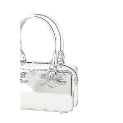 Luxurious leather handbag with two tubular handles and metallic feet