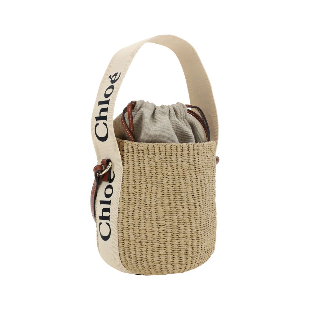Interior pouch with drawstring closure and cotton handle with brand logo